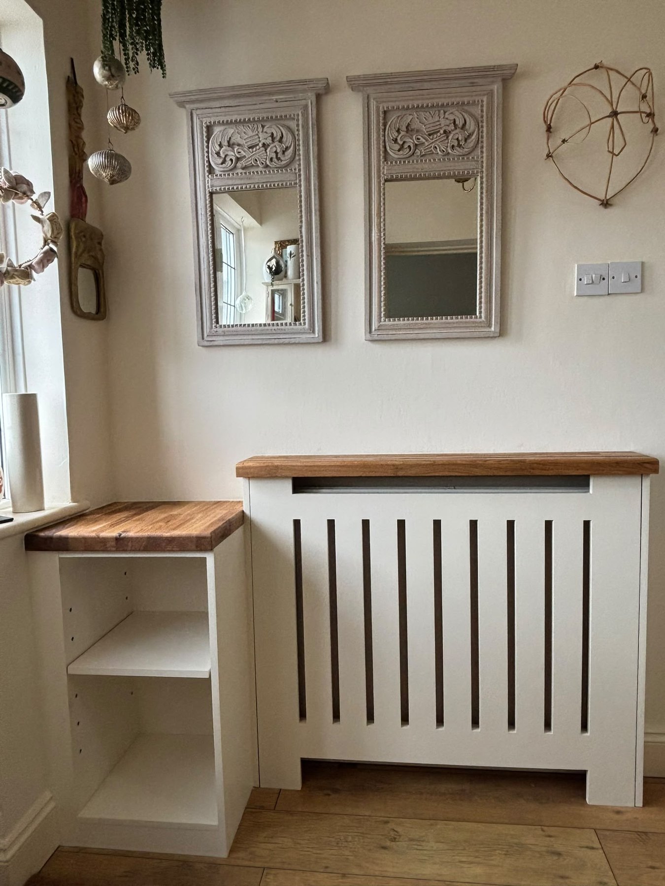 Slatted painted radiator cover with a solid oak top and a fitted corner shelf