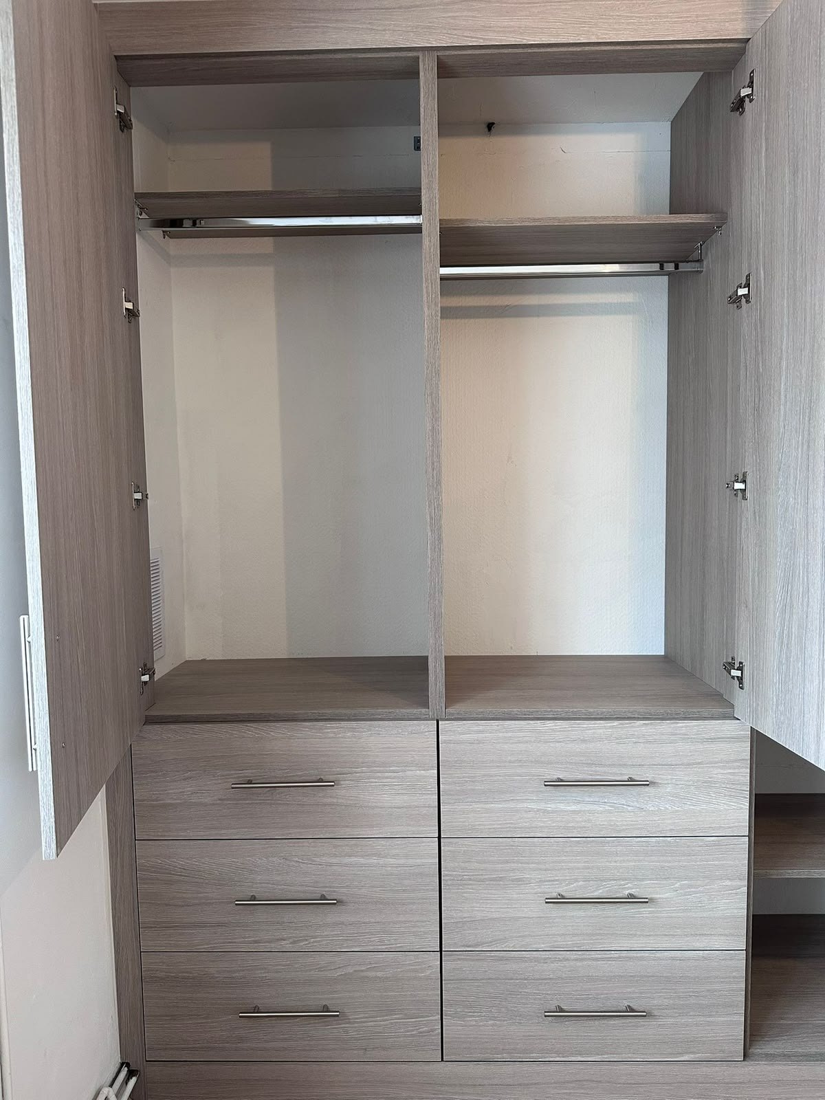 Inside the Feltham wardrobe: two hanging rails, a top shelf and six soft-close drawers