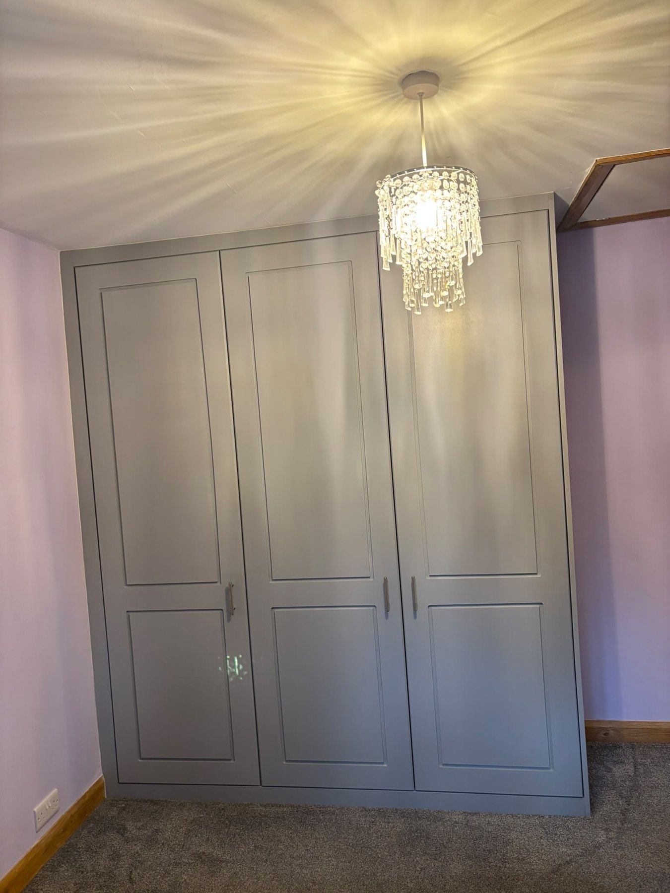 Four-door painted fitted wardrobe in a shaker style, built floor to ceiling